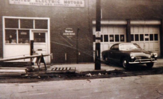 Historic image of United Electric Motors Building and car