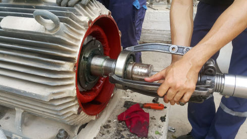 Employee working on mechanical motor