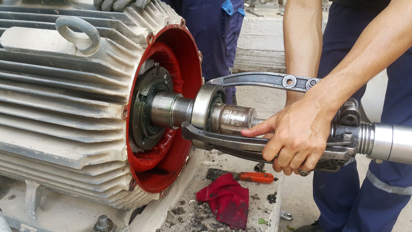 Employee working on mechanical motor